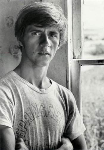 Black and white photo of Walter in his twenties standing by a window.