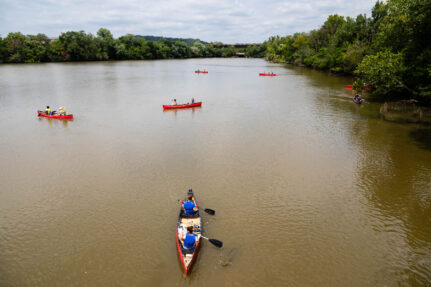 Aerial view of people kayaking down a river.