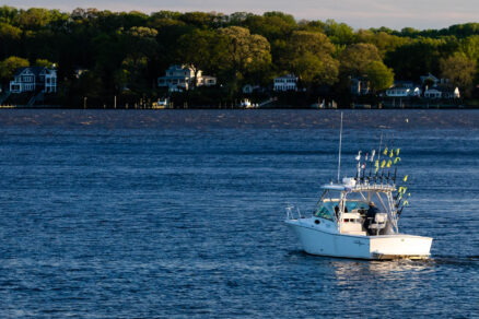 A boat glides down the river.