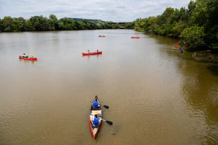 Aerial view of people kayaking down a river.