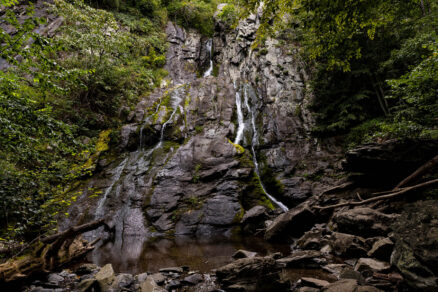 Thin waterfall cascading down a steep cliff.
