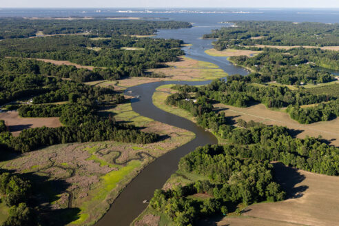 Chuckatuck Creek flows into the James River, surrounded by farmland and forest.