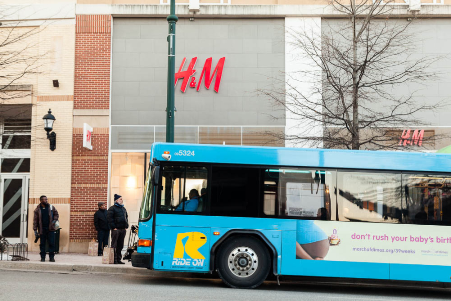 A bus pulls up to a bus station.
