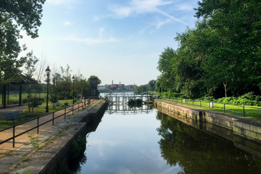 A historic ship lock bordered by woods and pedestrian trails.