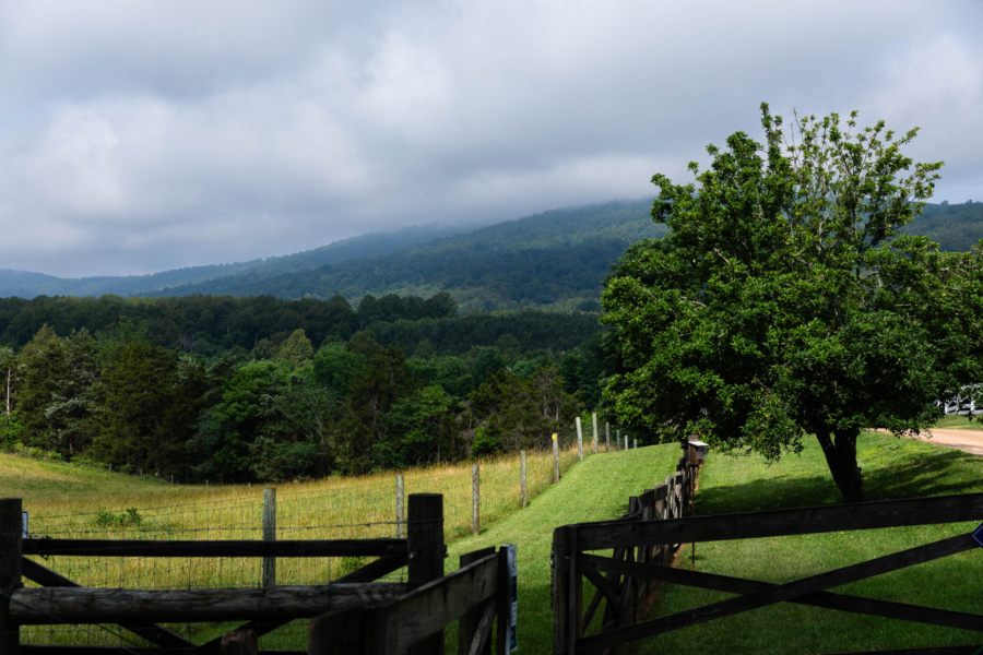 Photo showing the landscape of Highland: farm field, walking trail, and mountains in the background.