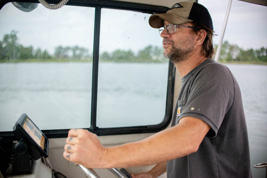 Military veteran Daniel Knott steers a boat on the Chesapeake Bay.