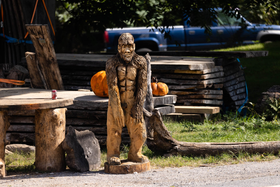 A figure of Bigfoot stands outside a wood carving business