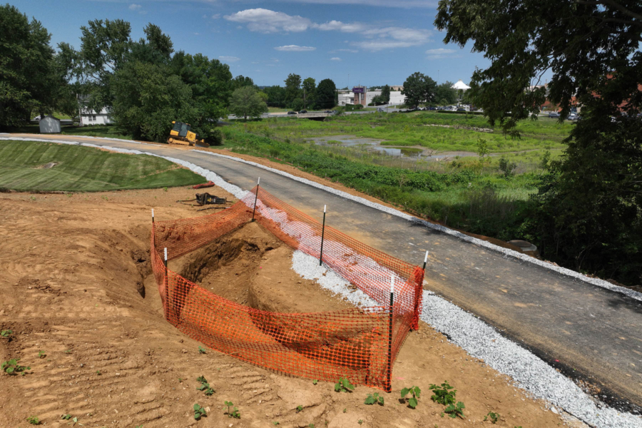 A paved trail near an in-progress environmental construction site.
