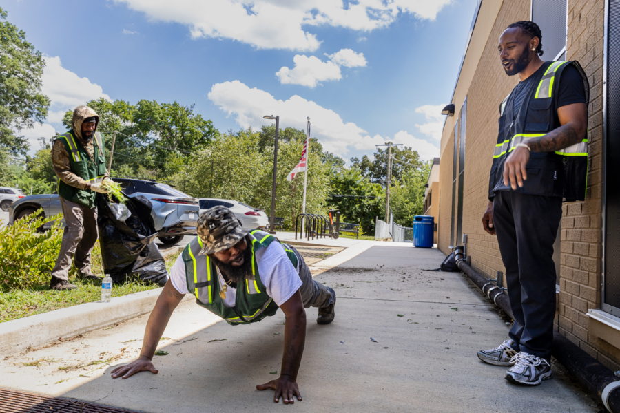 Charles looks down at Young, in the push-up position looking back up at Charles