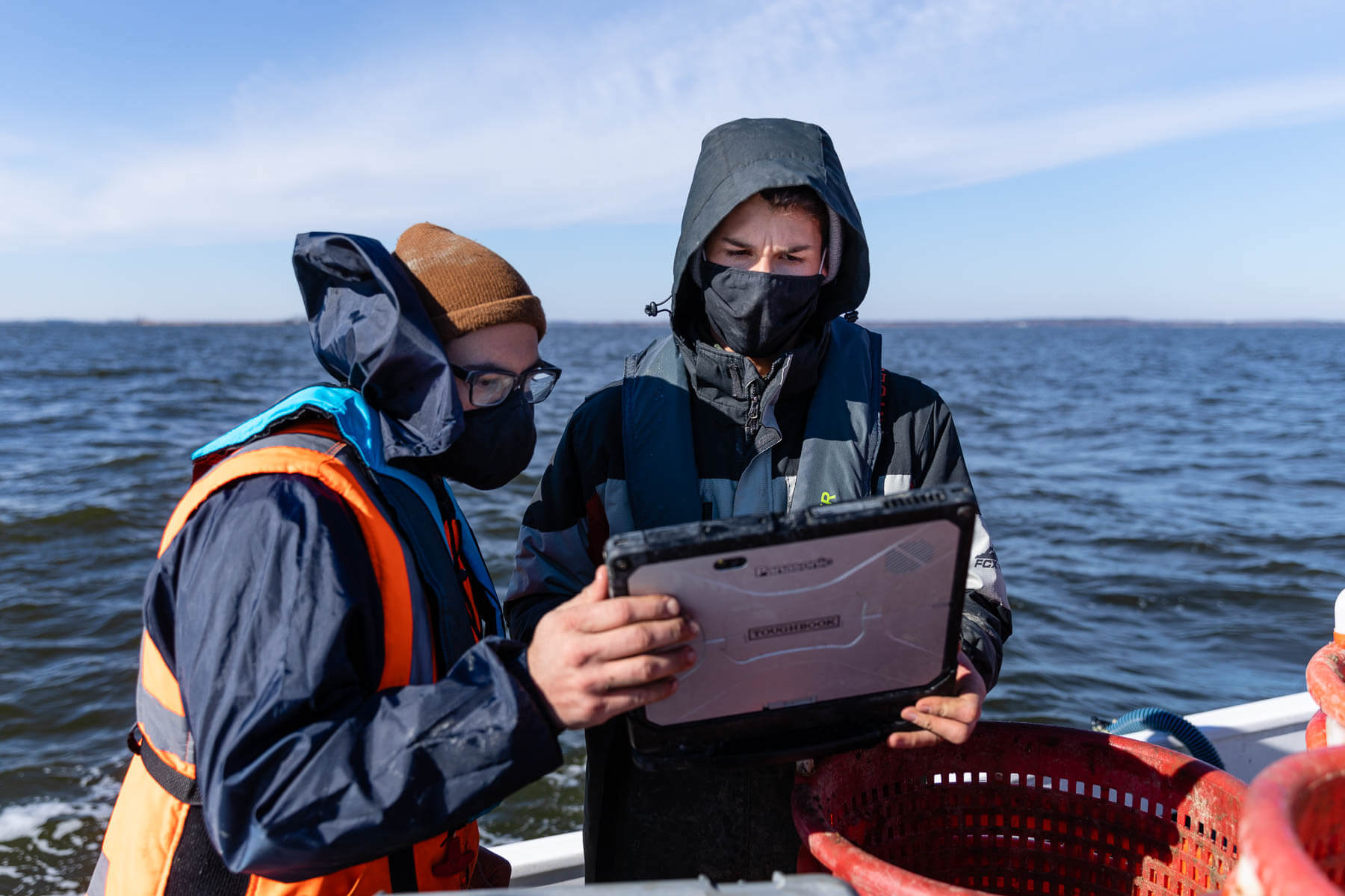 Technicians focus on laptop onboard workboat